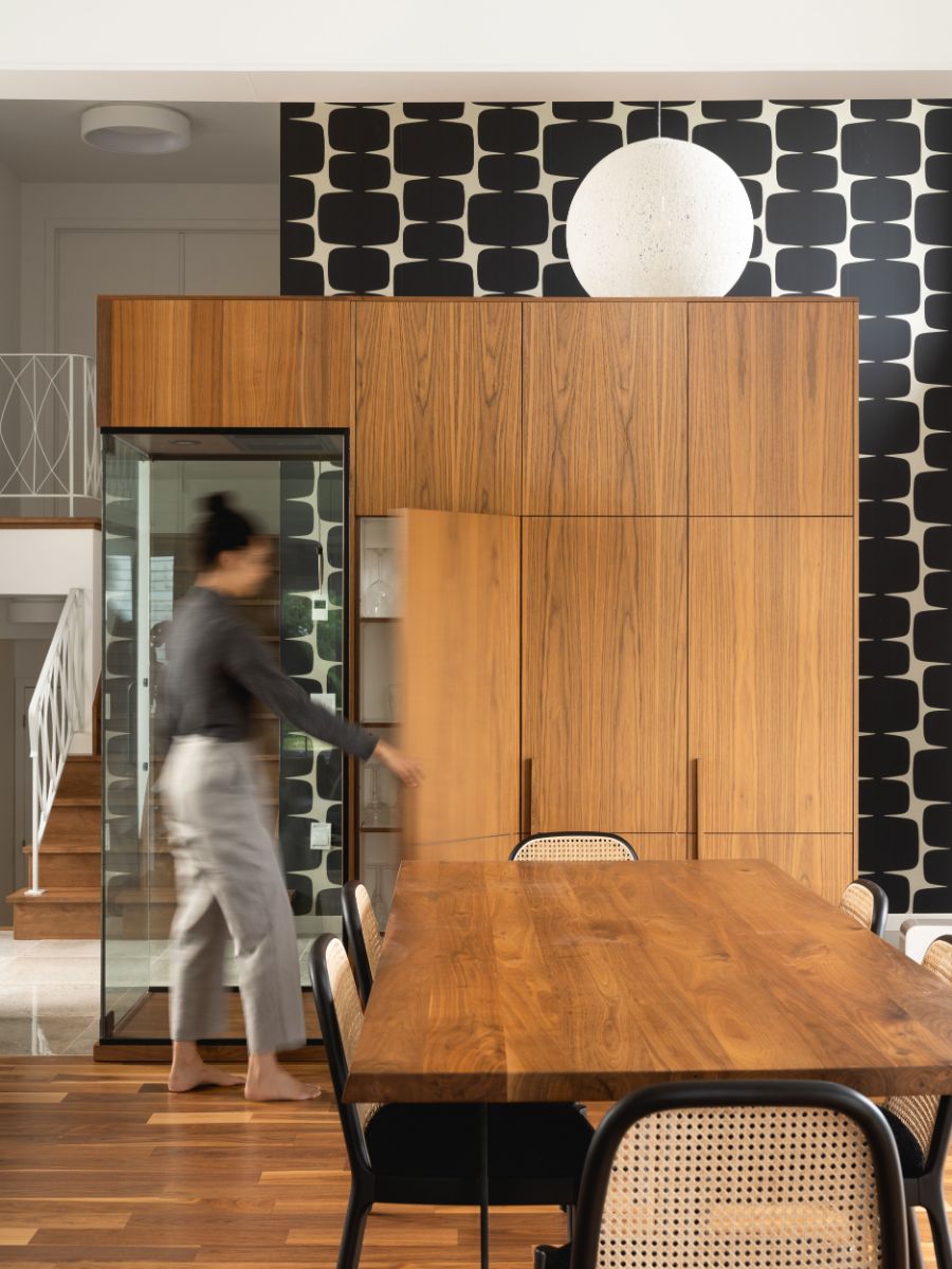 Dining area with wooden cabinets, customized wall decors and lighting.