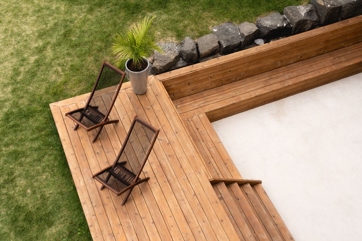 Outside patio with two lounge chairs surrounded with bermuda grass.