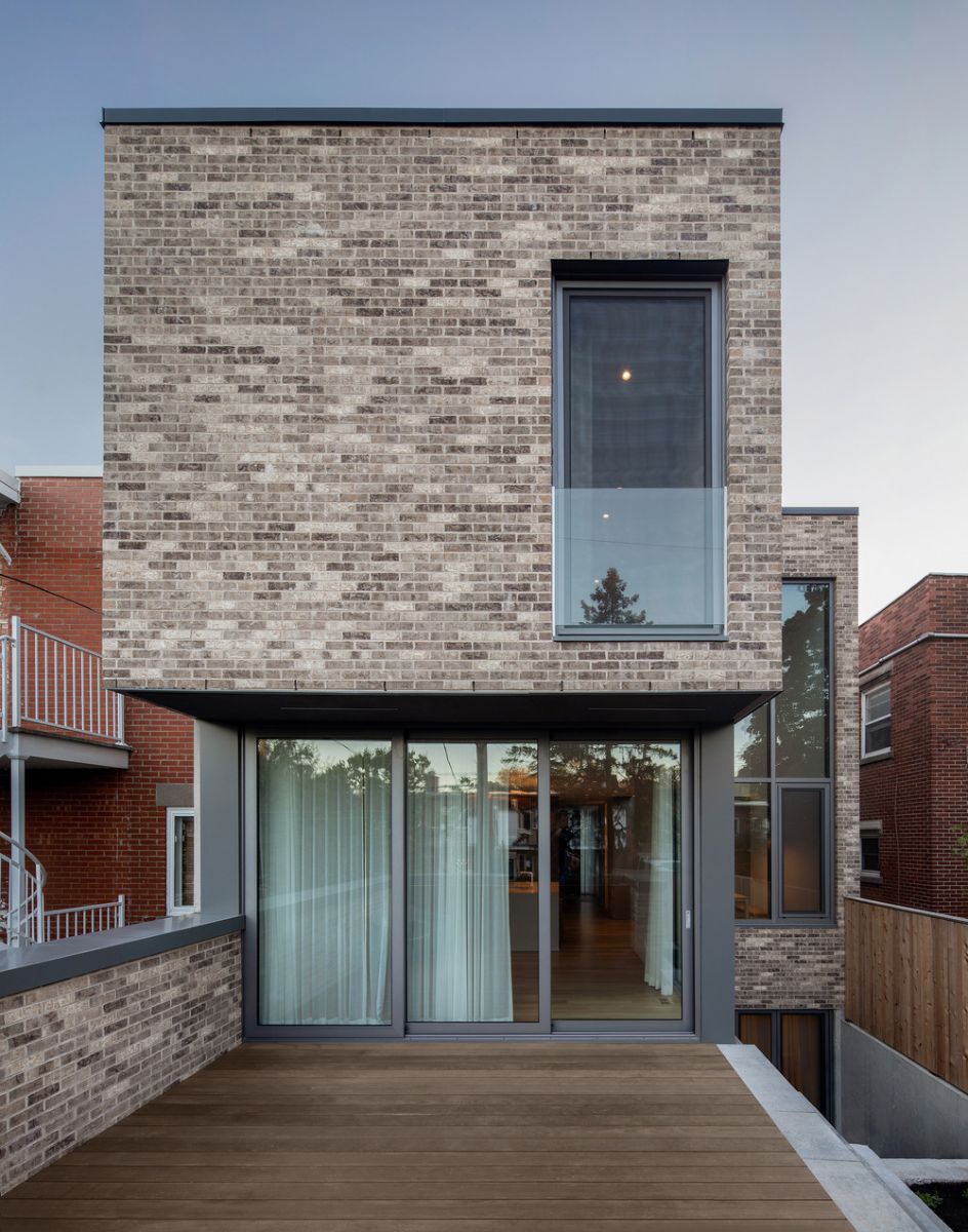 The patio of the house surrounded by a low brick wall.