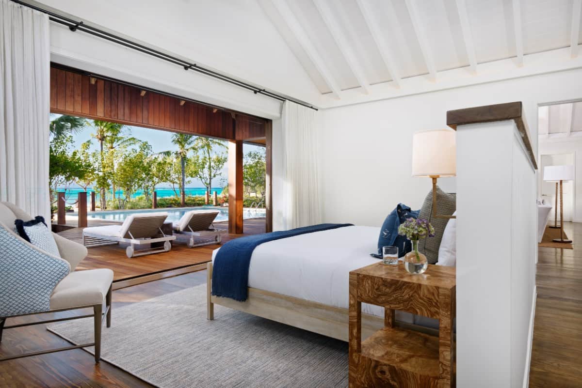 Another bedroom with pool deck access and cathedral beamed ceiling. Image courtesy of Toptenrealestatedeals.com.