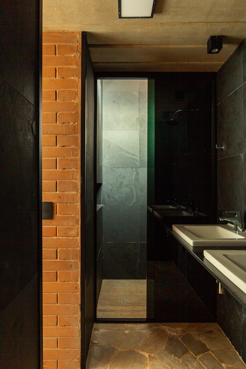 The bathroom dual sink with a door leading to the shower room.