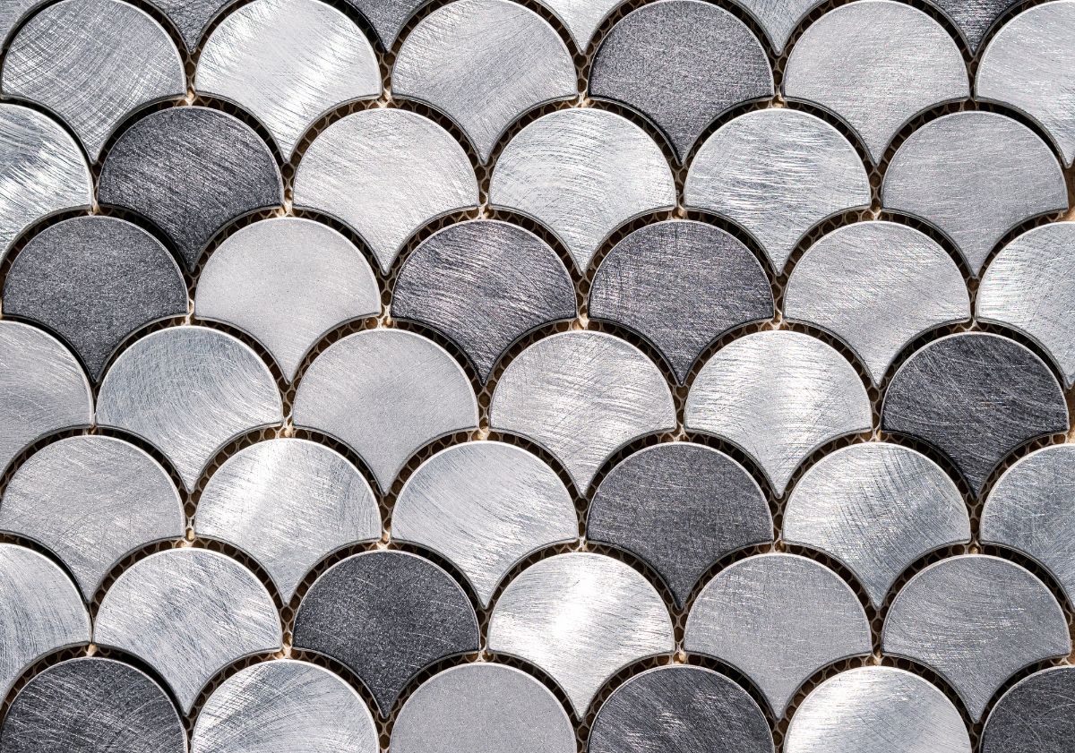 A mosaic made from metal with scales designs.