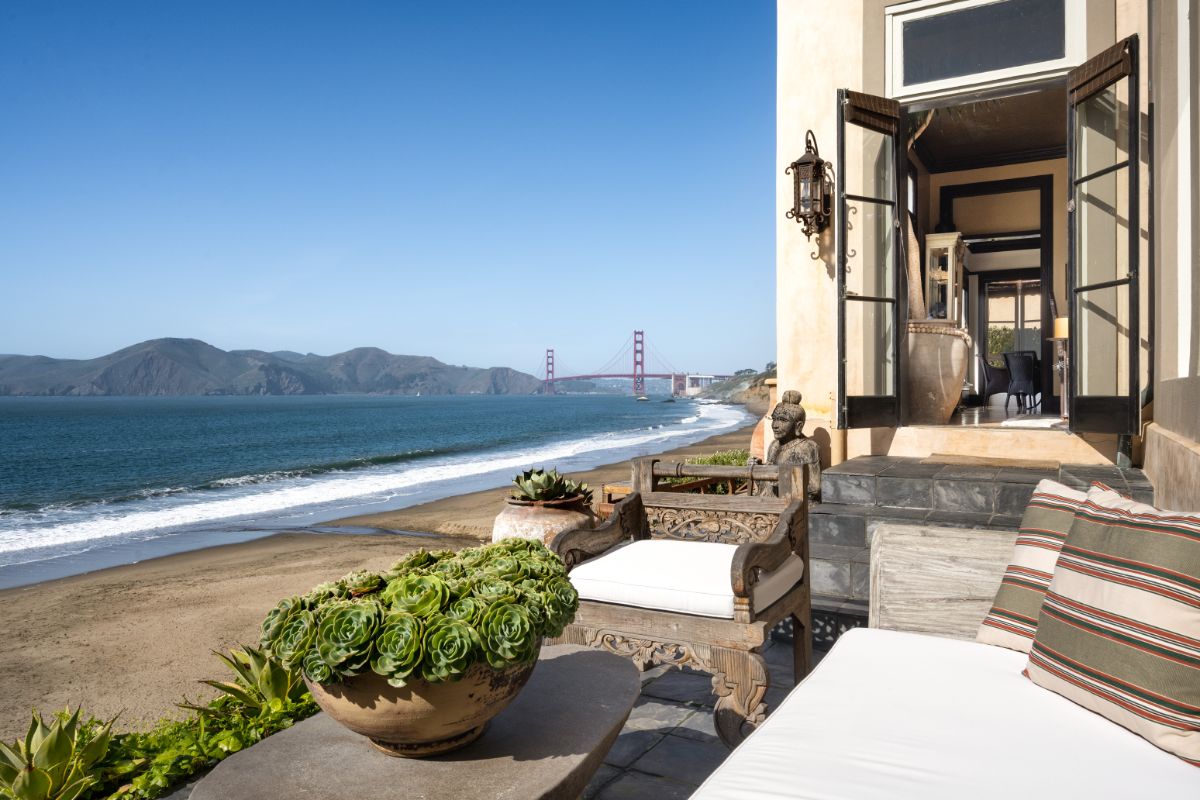 French doors open off the main level to this lounge area with two sun decks. Image courtesy of Toptenrealestatedeals.com