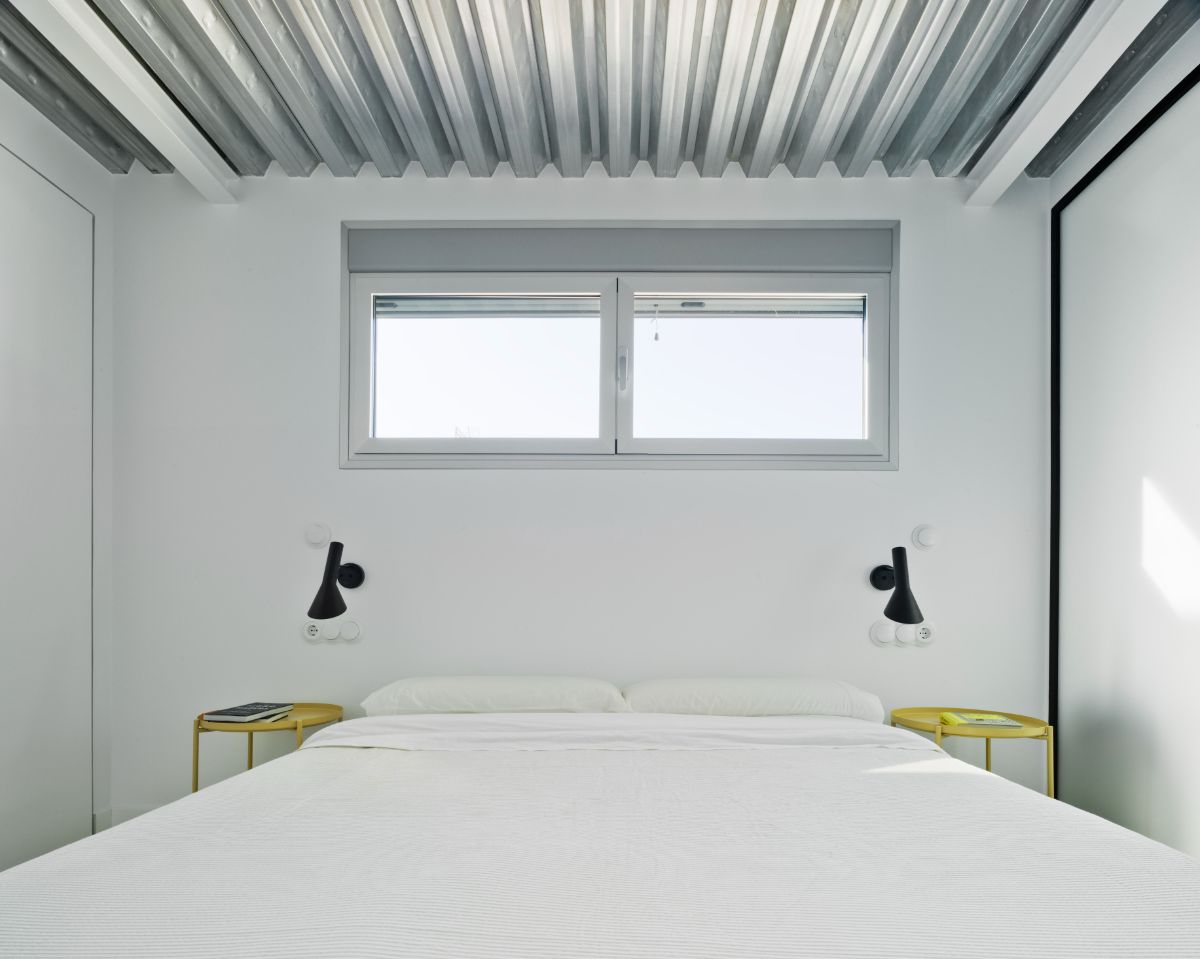 The primary bedroom that features vertical beamed-ceiling.