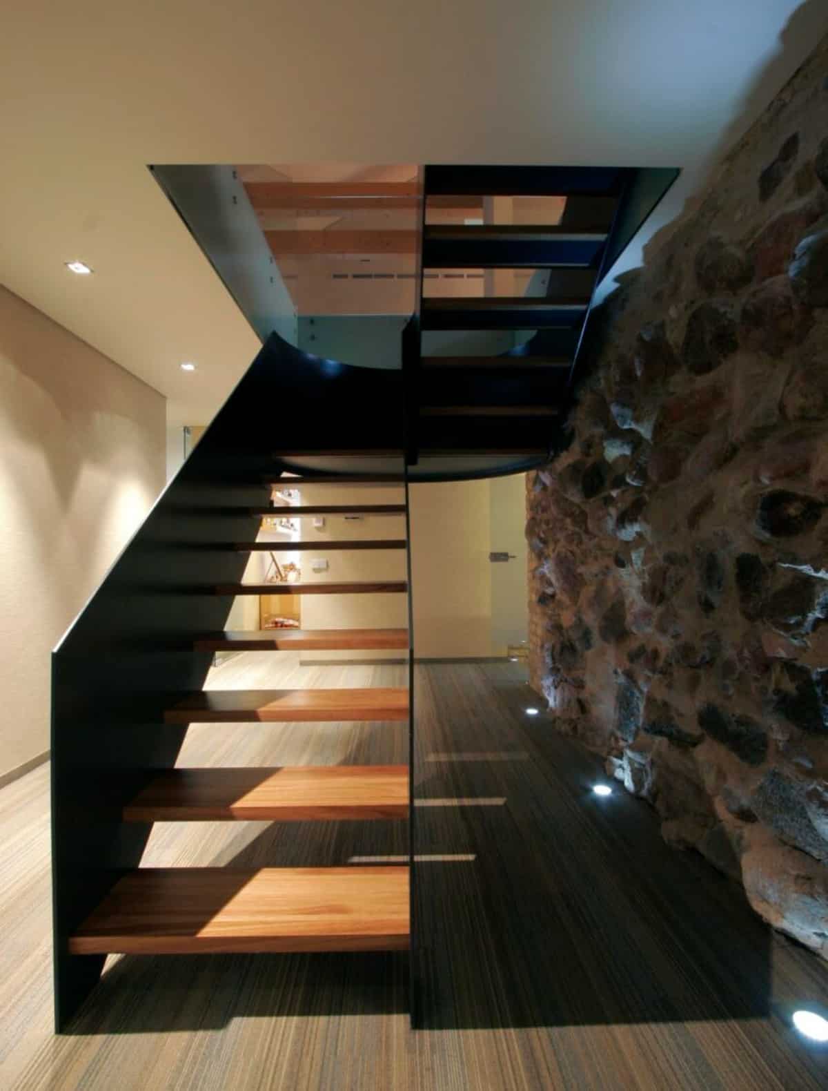 The house staircase that features a dark wooden.