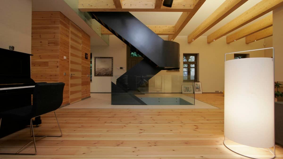 The house interior that features a cozy hardwood floor and dark wood furnishings.