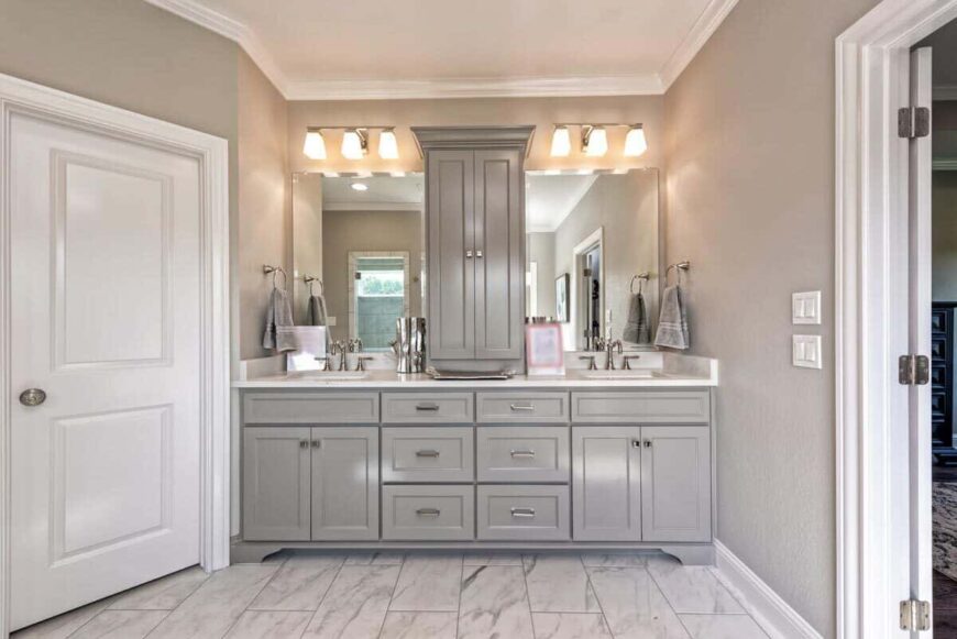 Primary bathroom with dual sink vanity topped with a gray cabinet and frameless mirrors.