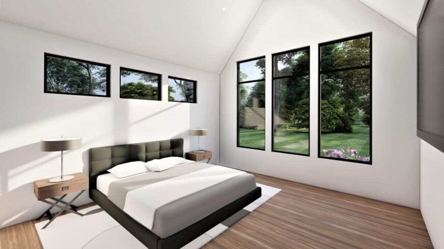 Primary bedroom with a gray upholstered bed and wooden nightstands that match the hardwood floor.