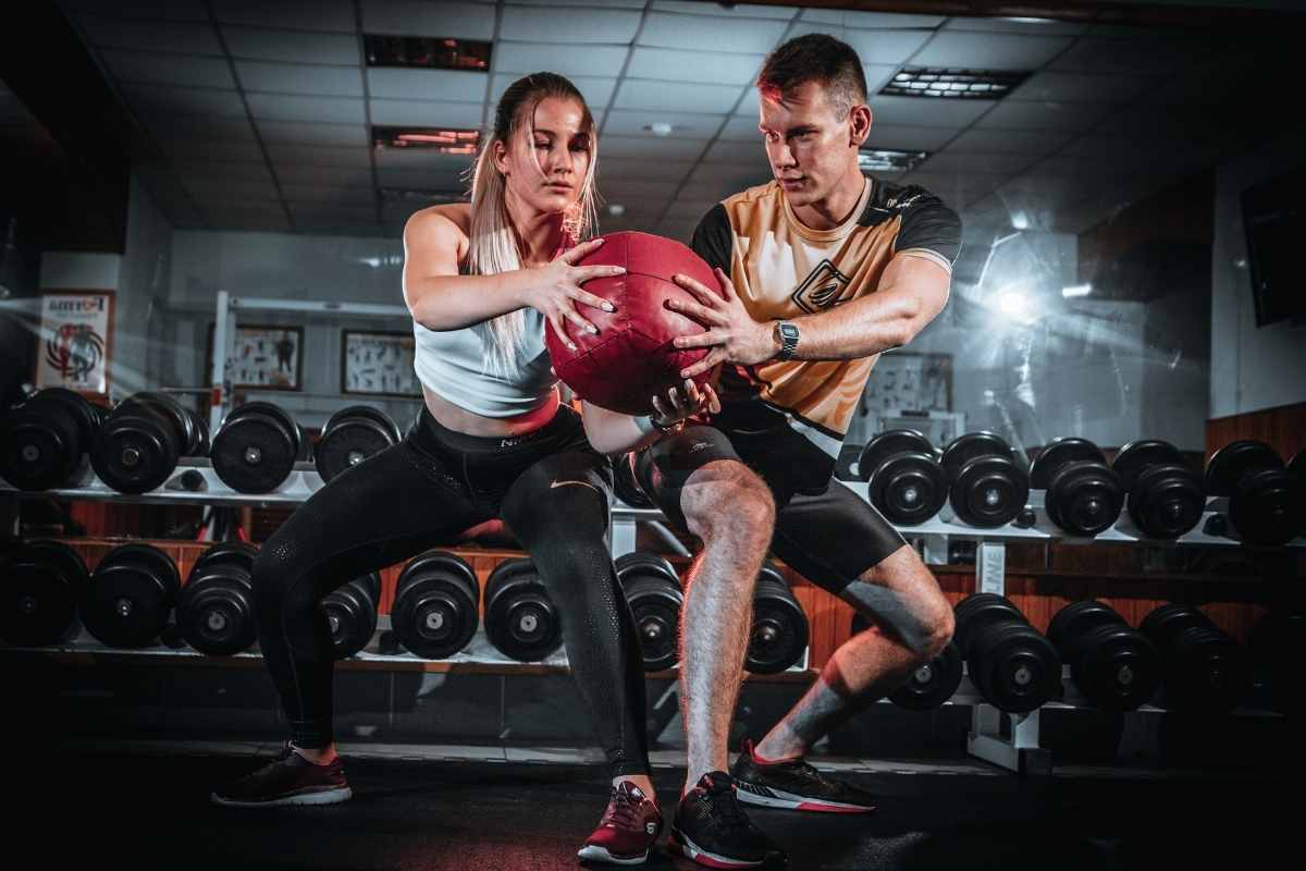 A couple exercising together using a medicine ball.