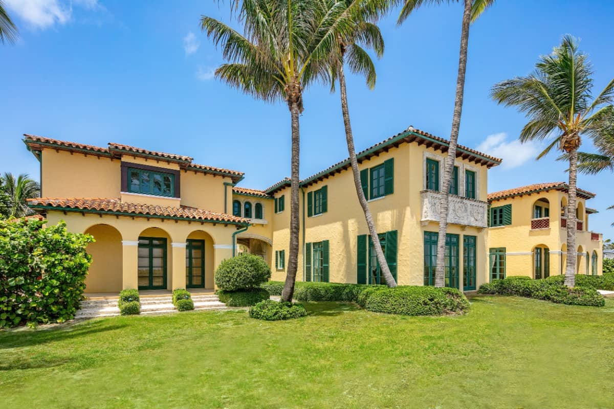 Green lush lawn and bushes add a nice contrast to the yellow exterior walls. Image courtesy of Toptenrealestatedeals.com.