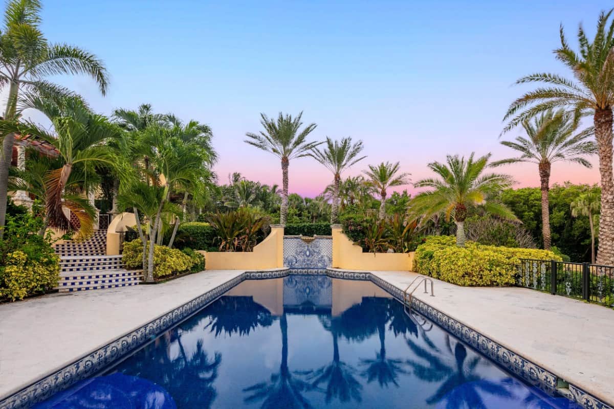 The swimming pool sets an elegant focal point in the backyard. Image courtesy of Toptenrealestatedeals.com.