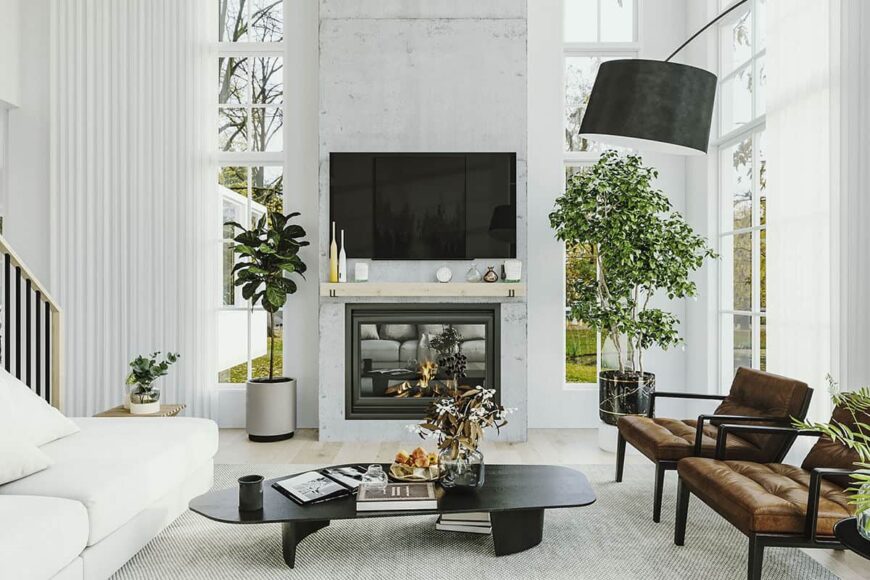 The living room includes leather armchairs and a TV mounted above the glass-paneled fireplace.