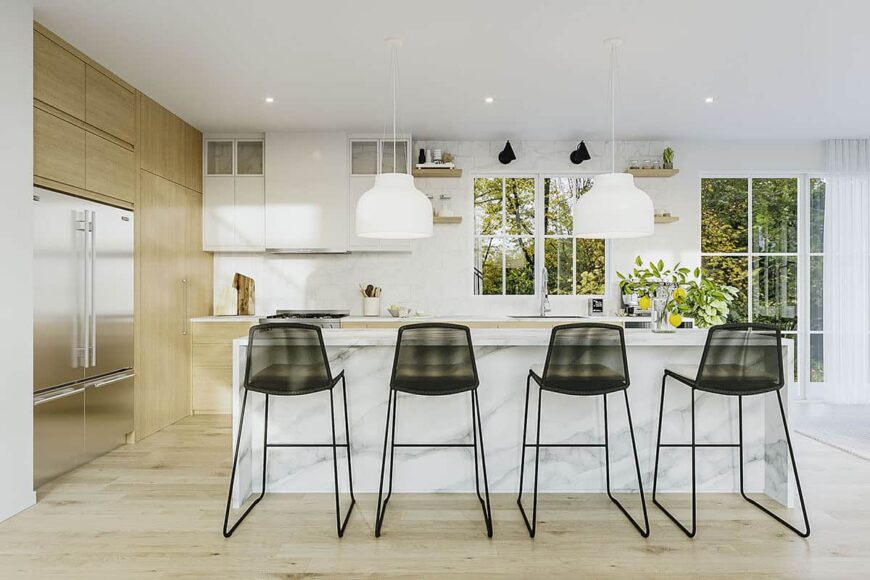 Metal counter chairs and white dome pendants complement the kitchen island.