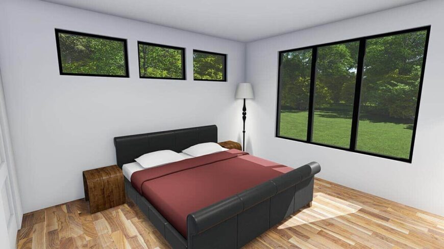 Primary bedroom with a hardwood floor, a leather upholstered bed, and large windows overlooking the backyard.