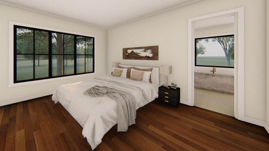 Primary bedroom with a private bath and a trio of windows overlooking the backyard.