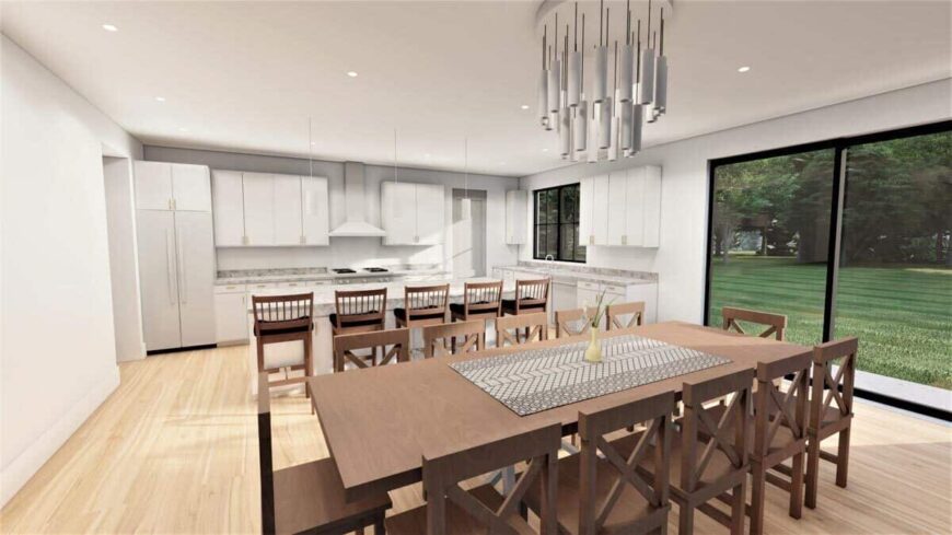 Eat-in kitchen with a wooden dining set, white cabinetry, and sliding glass doors that open onto the rear deck.