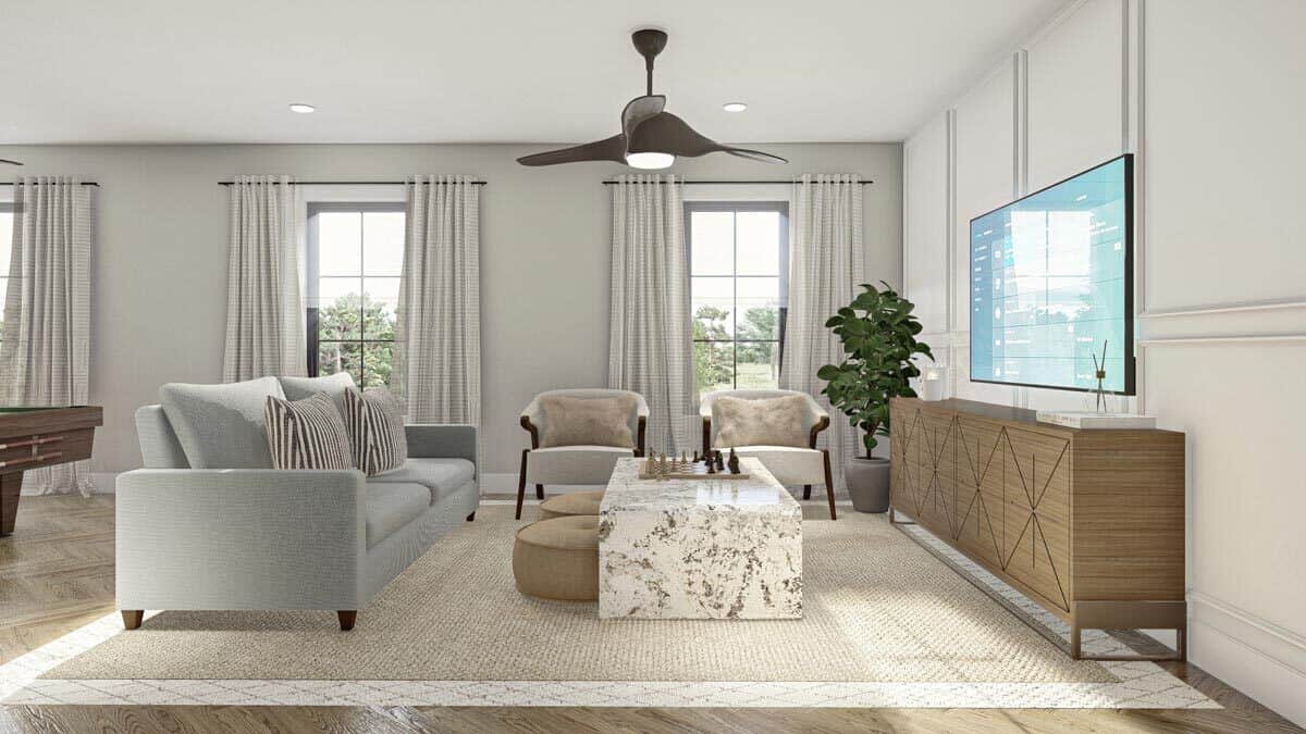 Living room with modern furnishings and a TV mounted against the wainscotted wall.