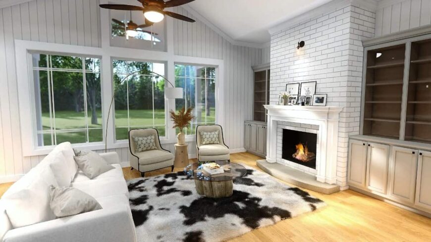 The living area offers a brick fireplace, comfy seats, and an expansive view of the backyard.