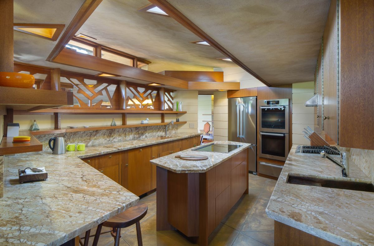 A large kitchen with a stone-topped island. Image courtesy of Toptenrealestatedeals.com