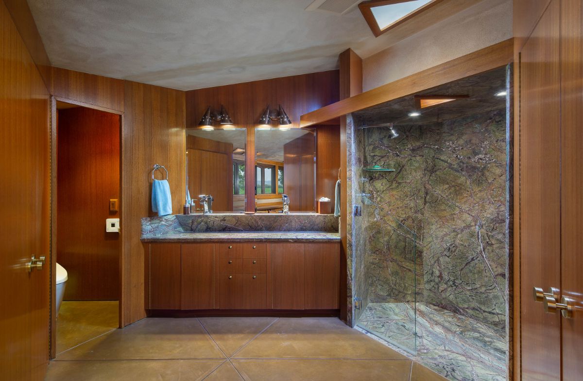 The main bathroom, which includes marble and hardwood accents in the shower area. Image courtesy of Toptenrealestatedeals.com