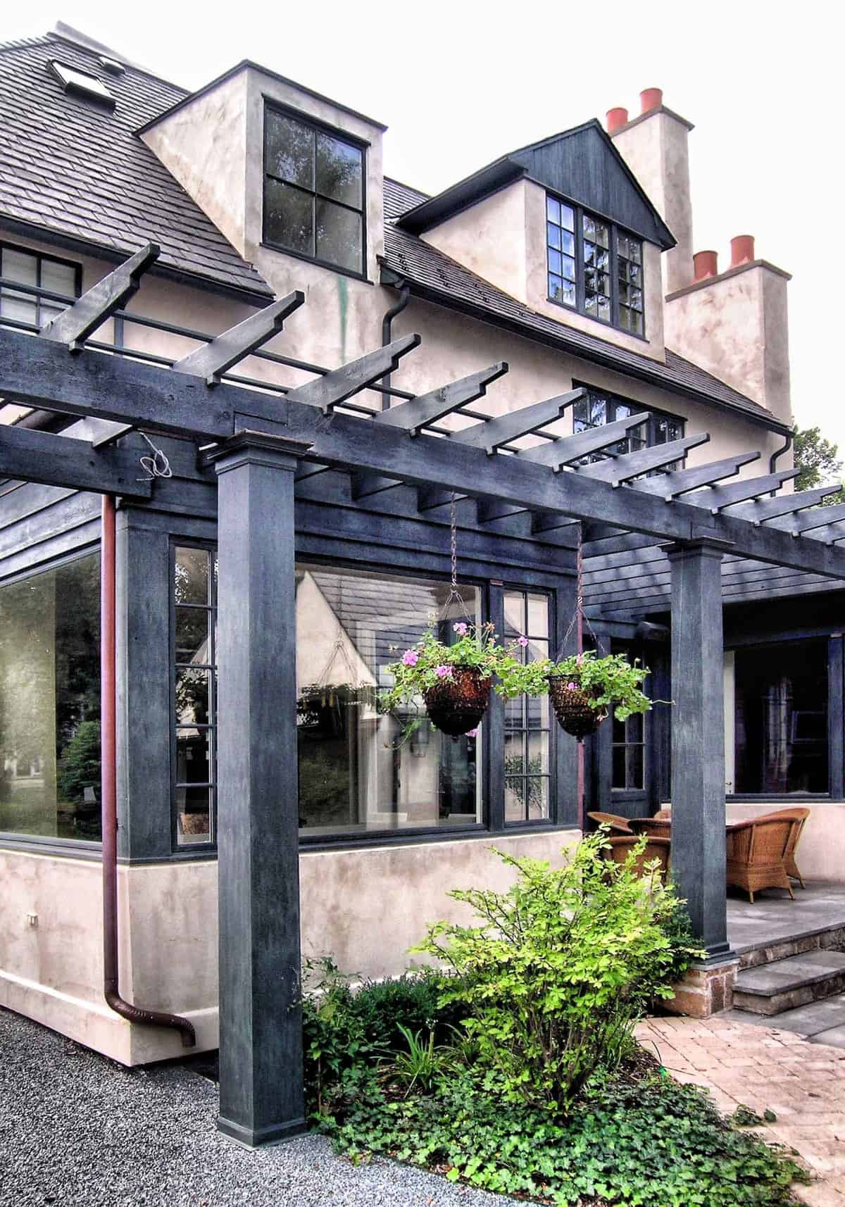 Hanging plants with beautiful flowers adorn the trellis porch.