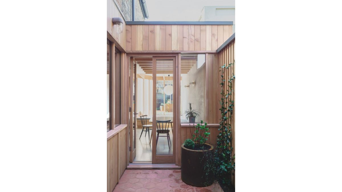 The spacious kitchen and dining area, which opens to a walled backyard, has a little inset courtyard.