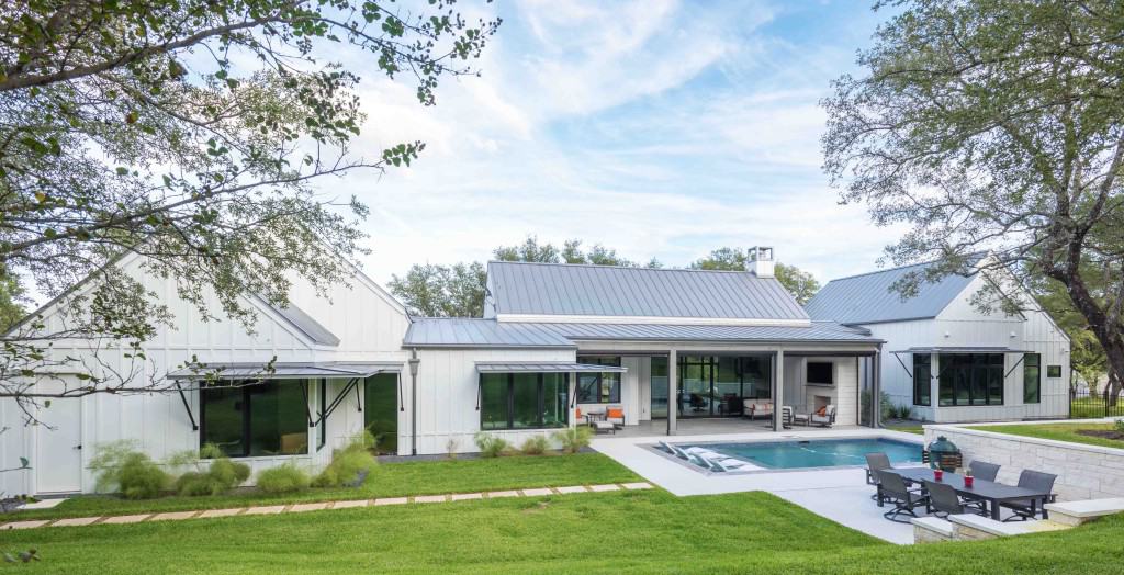 An angled view shows the stone walkway leading to the sparkling pool.