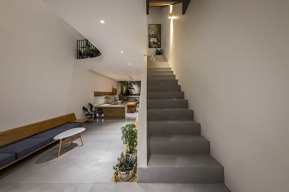 The concrete tiled flooring is echoed on the staircase for a cohesive look.