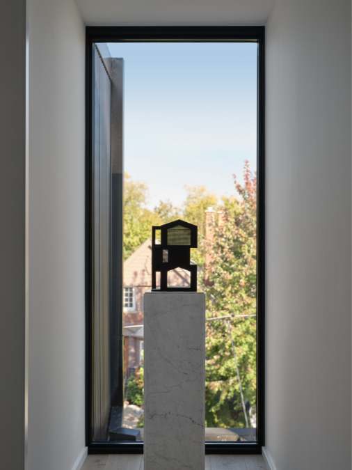 A close-up shot of a slim window that offers a picturesque view of the exterior surroundings.