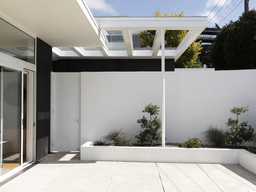 An exterior photograph of the open outdoor area adjacent upstairs of Salmont Place, providing access to the main living room.