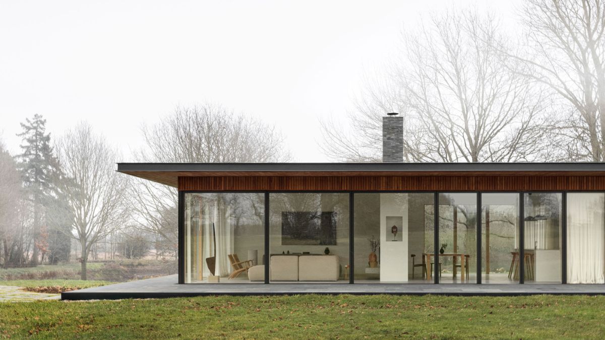 The basis of the structure is a dark basalt platform house with a shadow gap between the land and the plinth, giving the impression that the house is raised above the ground.