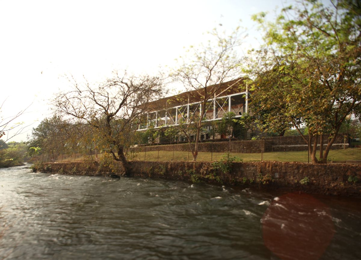 The veranda has large windows with a view of the stream and surroundings.