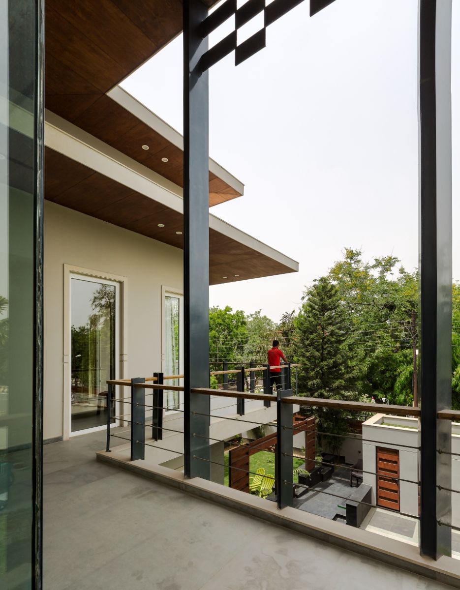 The upper veranda provides a relaxing view of the surrounding greenery.