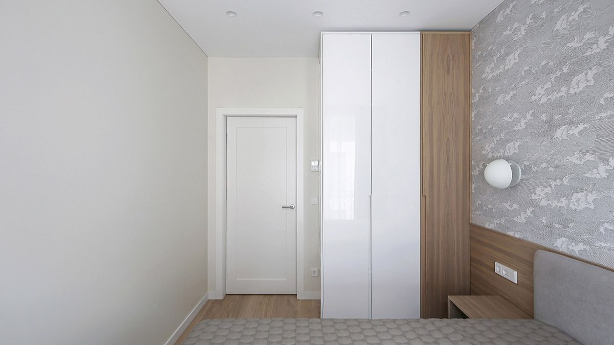 Another perspective inside the bedroom is facing the door. Beside it is a white wall closet.