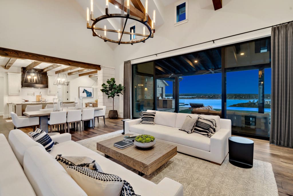 Ambient lighting from the contemporary chandeliers brings a cozy vibe to the open living space.