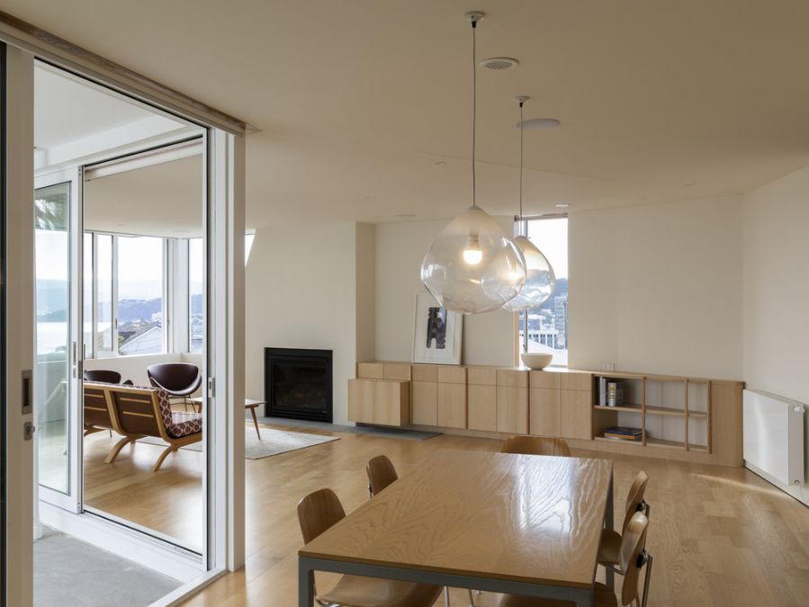 Interior shot of the dining area of the downstairs apartment leads to its living area on the left side.