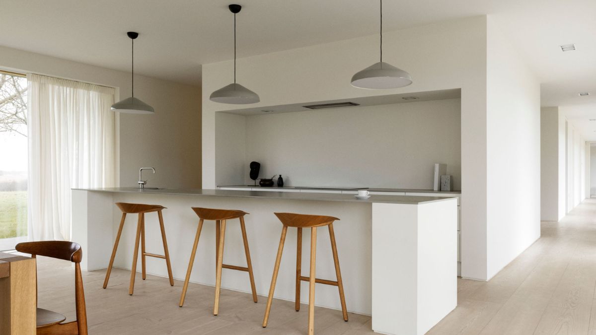 A central brick core with a wood burning stove divides the cosy living room from the large kitchen and dining area.