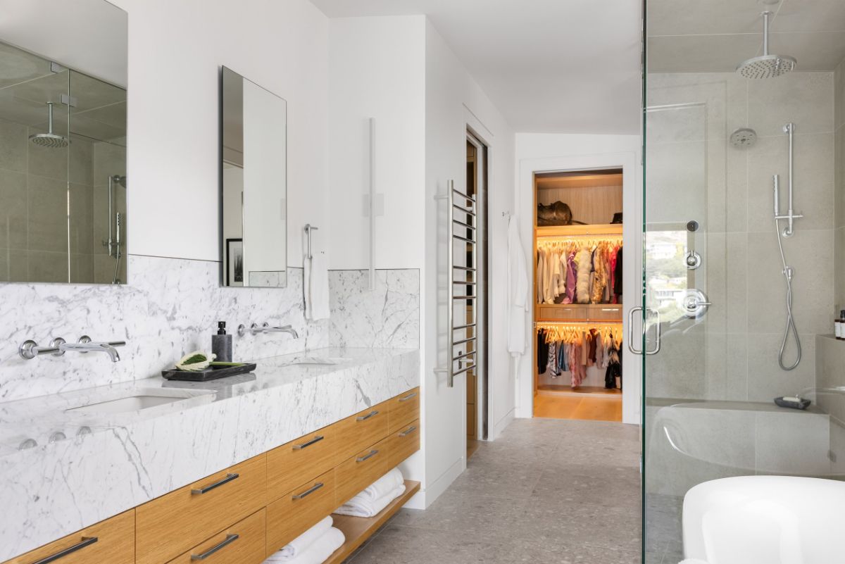 The master bathroom has a dresser and a sink with a granite countertop.