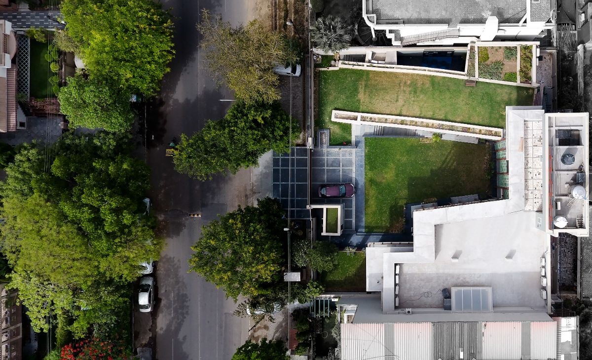 Aerial view of a bungalow house on a substantially smaller plot. 