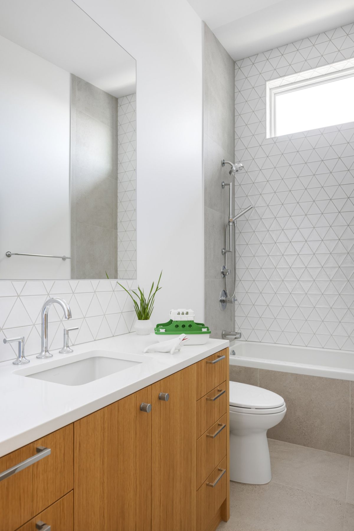 The small bathroom has an Alcove bathtub and a toilet seat.