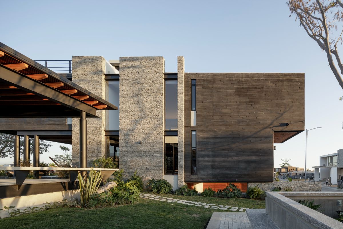 A stone walkway leads to the open dining area and patio.