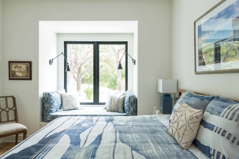 The primary bedroom features a cozy window seat perfect for reading books.