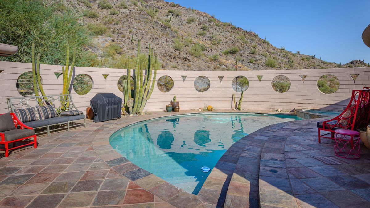 Beautiful stylish pool with a beautiful view of a mountain on one side; the mountain adds to the attractiveness of the outdoor space.