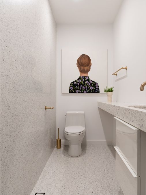 A close-up shot of a narrowed section of the bathroom elegantly complemented by a gallery-style wall art display, and adorned with golden rods.