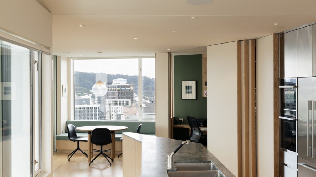 A shared image of the kitchen and breakfast dining area upstairs showcasing a view over the harbour.