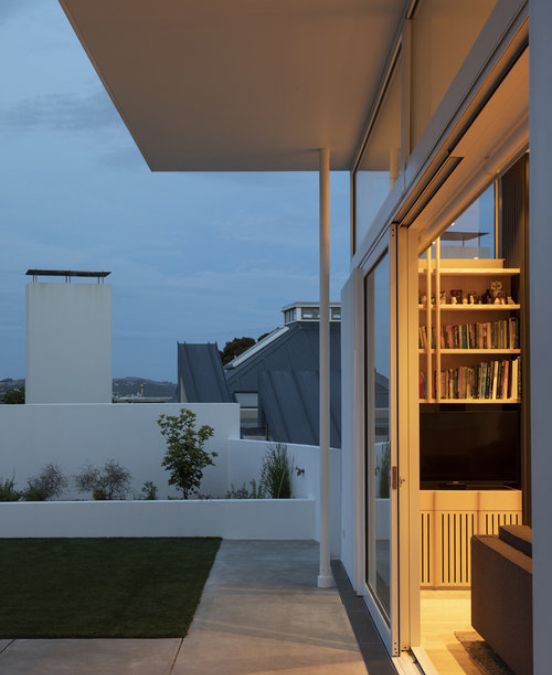 A close up photo of the outside terrace and lawn area upstairs during sunset.