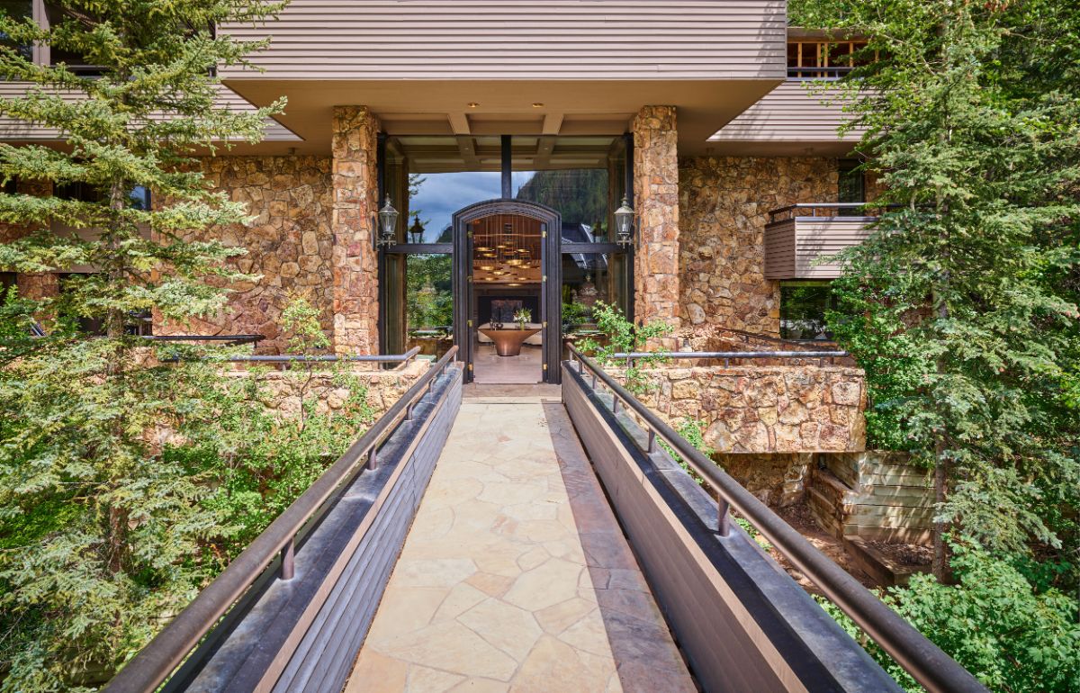 An elevated bridge connects the home's entry to the rest of the house. Image courtesy of Toptenrealestatedeals.com