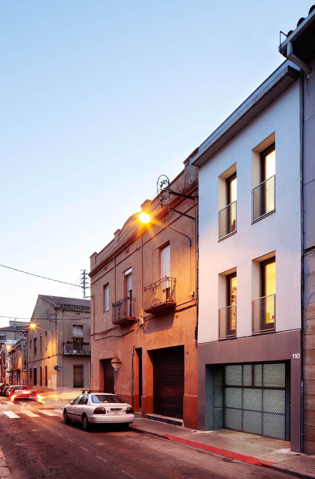 Compared to the windows of the neighboring houses, you can see that the building has been modified.