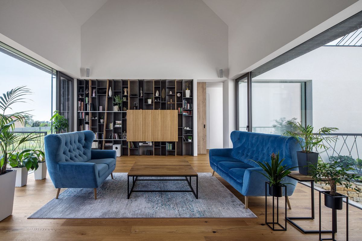 A living space with a generous bookcase hidden behind a sliding panel.