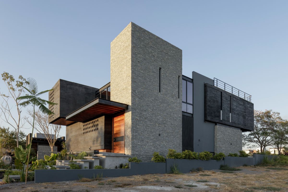 The texture of the volcanic stones blends with the concrete finish creating a rough exterior to the house.